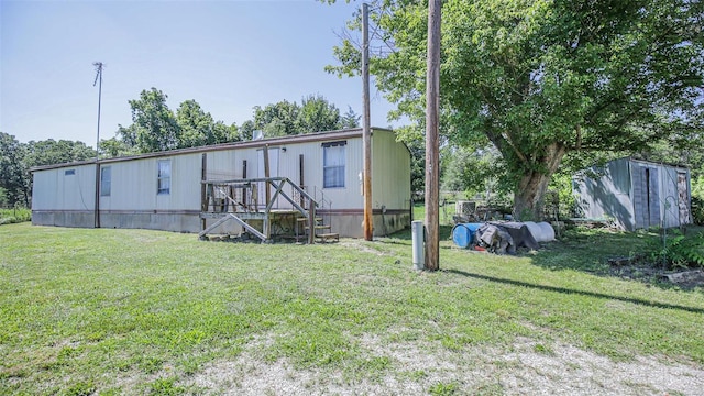 3340 Stonehouse Rd, De Soto, MO 63020 - manufactured / mobile home with a storage shed, a front yard, and an outdoor structure