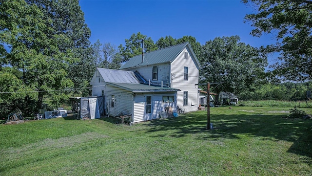 3340 Stonehouse Rd, De Soto, MO 63020 - back of house with a yard, metal roof, and view of wooded area