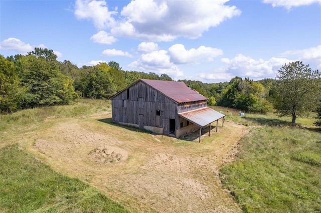 3340 Stonehouse Rd, De Soto, MO 63020 - view of home's exterior featuring an outdoor structure and a wooded view