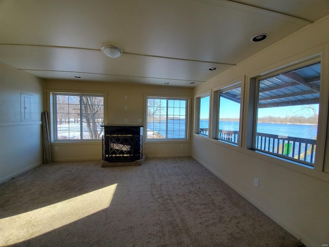 801 S Front St, La Grange, MO 63448 - unfurnished sunroom featuring baseboards, carpet, and a water view