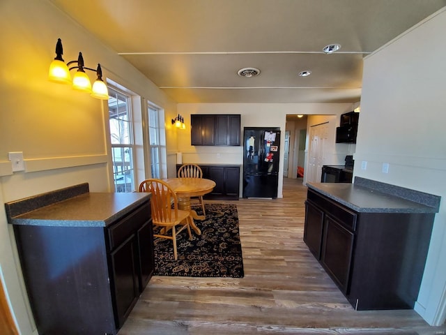 801 S Front St, La Grange, MO 63448 - kitchen featuring black appliances, dark countertops, and wood finished floors