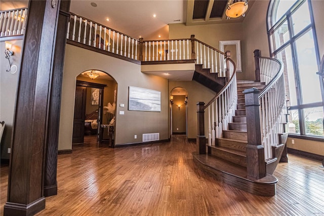 6708 Brown Ln, Poplar Bluff, MO 63901 - stairway with arched walkways, baseboards, a towering ceiling, hardwood / wood-style floors, and recessed lighting
