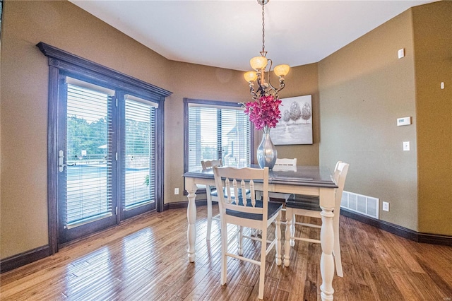 6708 Brown Ln, Poplar Bluff, MO 63901 - dining room with a chandelier, baseboards, and wood finished floors