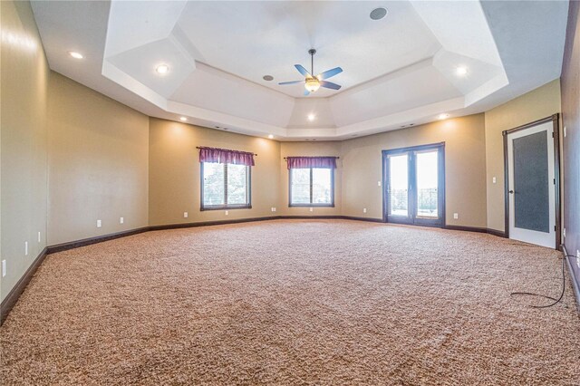 6708 Brown Ln, Poplar Bluff, MO 63901 - carpeted spare room featuring a ceiling fan, a tray ceiling, healthy amount of natural light, baseboards, and recessed lighting
