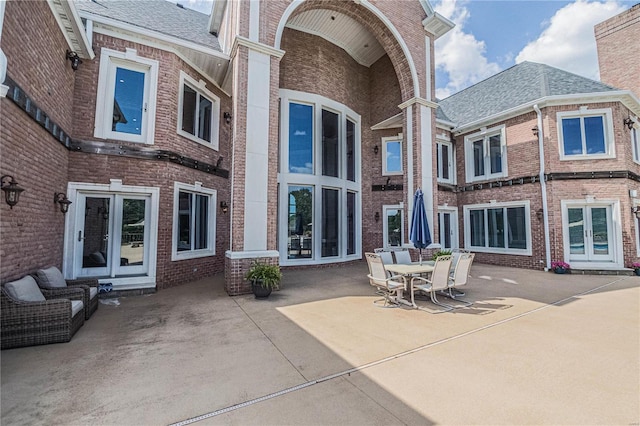 6708 Brown Ln, Poplar Bluff, MO 63901 - back of house featuring brick siding, french doors, and a patio