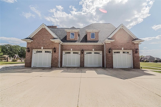 6708 Brown Ln, Poplar Bluff, MO 63901 - view of front facade featuring brick siding, driveway, and roof with shingles
