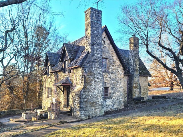 1475 Pottery Rd, Washington, MO 63090 - view of property exterior featuring a chimney and stone siding
