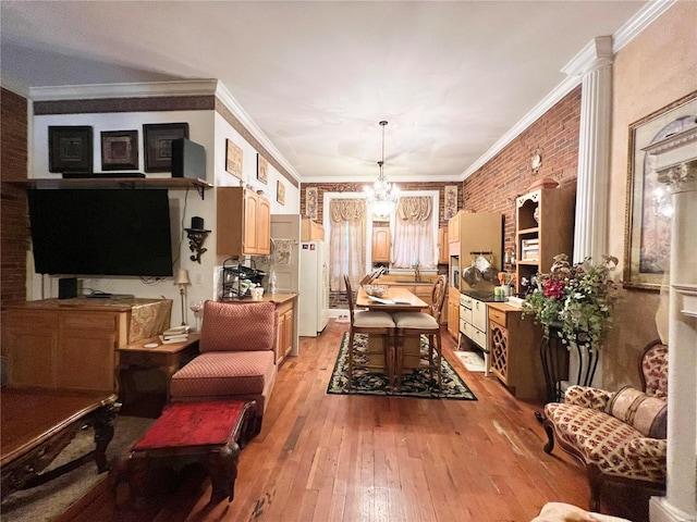 207 S Main St, Hannibal, MO 63401 - living room featuring a chandelier, light wood-type flooring, and crown molding