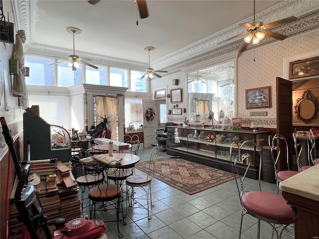 207 S Main St, Hannibal, MO 63401 - tiled living room featuring a ceiling fan, wallpapered walls, and ornamental molding