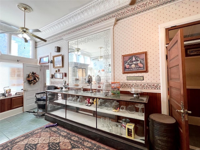 207 S Main St, Hannibal, MO 63401 - interior space featuring wallpapered walls, a ceiling fan, wainscoting, healthy amount of natural light, and tile patterned floors