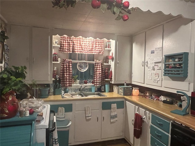 1409 Spring St, Poplar Bluff, MO 63901 - kitchen featuring a sink, black dishwasher, light countertops, and open shelves