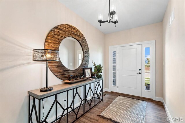 4 Challenger Ct, Ofallon, MO 63366 - entrance foyer featuring a chandelier, wood finished floors, and baseboards
