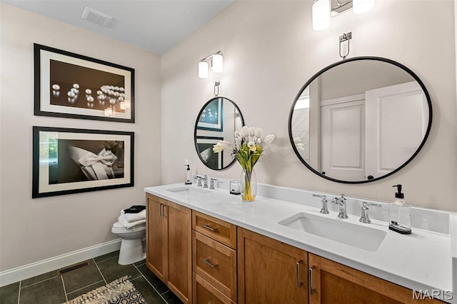4 Challenger Ct, Ofallon, MO 63366 - full bath with double vanity, toilet, tile patterned floors, and baseboards
