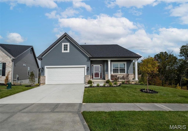 4 Challenger Ct, Ofallon, MO 63366 - view of front of house featuring a front lawn, driveway, a garage, covered porch, and stone siding