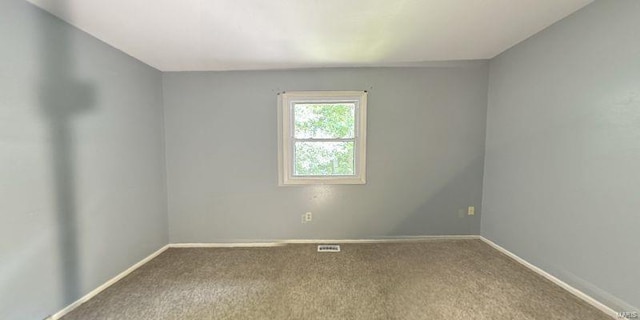 empty room with carpet flooring and baseboards
