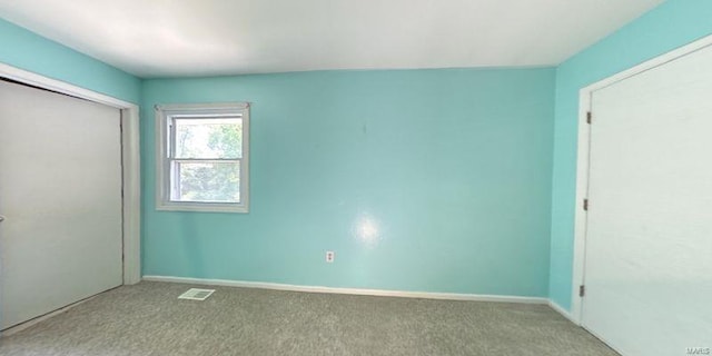 unfurnished bedroom with carpet flooring, a closet, and baseboards