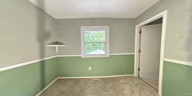 unfurnished room featuring carpet and baseboards