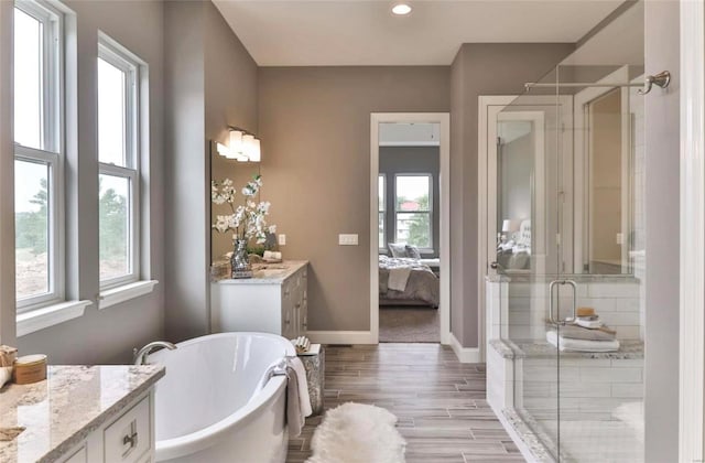 2632 Center Ave, Wildwood, MO 63040 - full bath featuring vanity, a stall shower, ensuite bath, a soaking tub, and wood finished floors