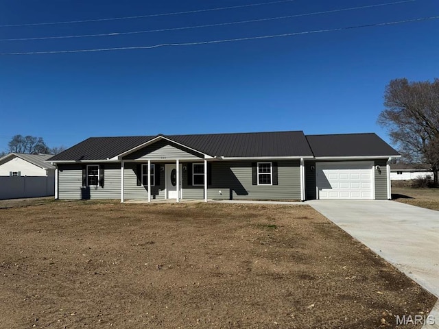 902 C St, Malden, MO 63863 - single story home with an attached garage, driveway, metal roof, a porch, and fence