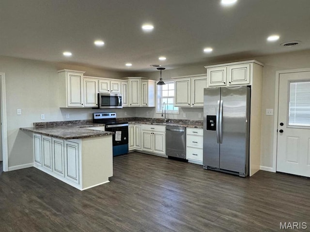 902 C St, Malden, MO 63863 - kitchen with appliances with stainless steel finishes, a sink, a peninsula, dark wood-style floors, and baseboards