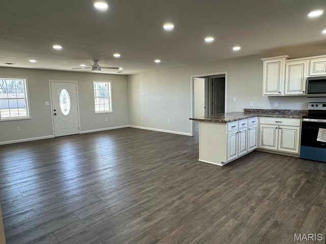902 C St, Malden, MO 63863 - kitchen featuring appliances with stainless steel finishes, a peninsula, dark wood-style flooring, baseboards, and open floor plan