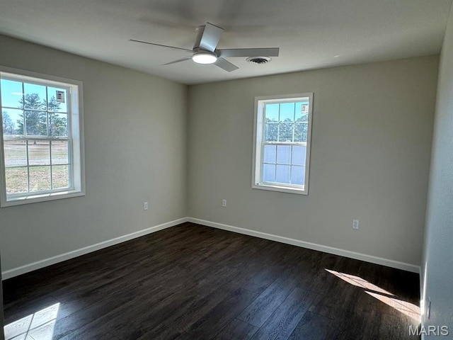 902 C St, Malden, MO 63863 - empty room featuring dark wood-style flooring, baseboards, and a ceiling fan