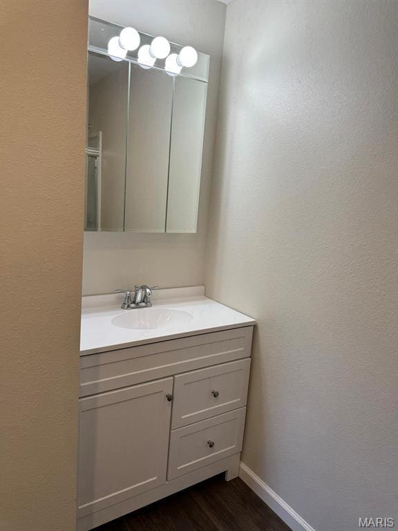 902 C St, Malden, MO 63863 - bathroom with vanity, wood finished floors, and baseboards