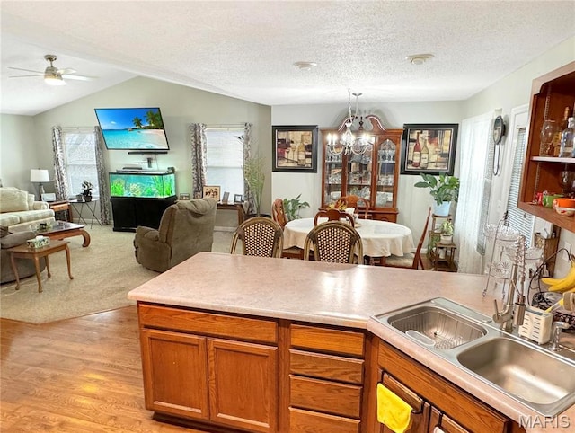 21 Forest Ln, Union, MO 63084 - kitchen featuring a chandelier, open floor plan, ceiling fan, light wood-type flooring, and brown cabinetry