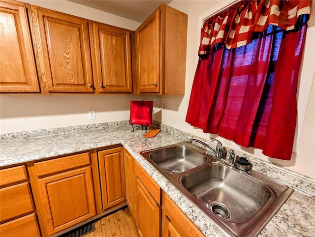 1035 Park Ave, Poplar Bluff, MO 63901 - kitchen with a sink, brown cabinets, and light wood-type flooring