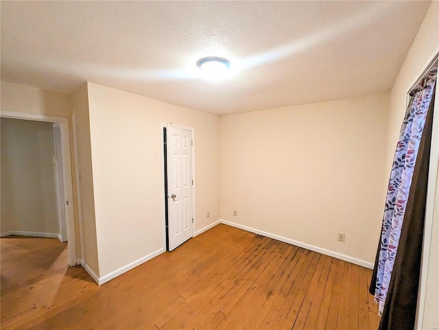 1035 Park Ave, Poplar Bluff, MO 63901 - unfurnished room with light wood-style floors, baseboards, and a textured ceiling