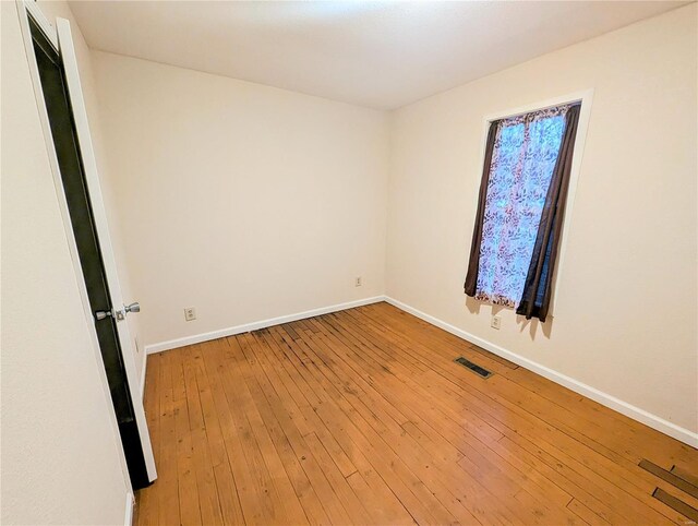 1035 Park Ave, Poplar Bluff, MO 63901 - spare room featuring baseboards and wood-type flooring