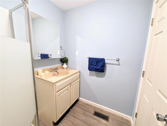 1035 Park Ave, Poplar Bluff, MO 63901 - bathroom with wood finished floors, baseboards, and vanity