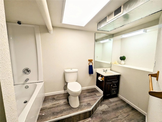 1035 Park Ave, Poplar Bluff, MO 63901 - full bath featuring wood finished floors, toilet, vanity, baseboards, and shower / washtub combination