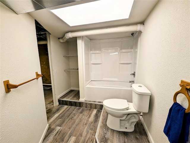 1035 Park Ave, Poplar Bluff, MO 63901 - bathroom featuring wood finished floors, baseboards, toilet, and a textured wall