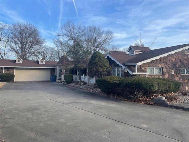 12746 Rolling Hills Dr, Trenton, IL 62293 - view of front of house with concrete driveway, a garage, a shingled roof, and stone siding