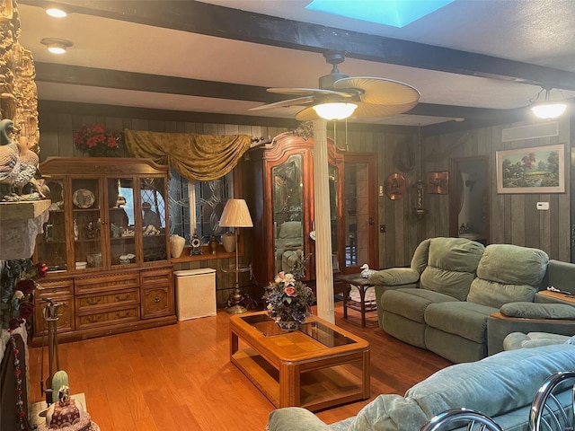 12746 Rolling Hills Dr, Trenton, IL 62293 - living area with wood walls, a skylight, a ceiling fan, beamed ceiling, and wood finished floors