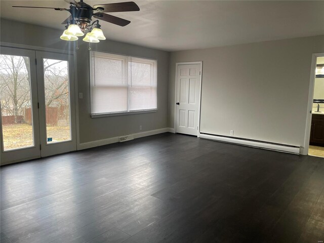 633 E State, Union, MO 63084 - unfurnished room featuring a baseboard heating unit, ceiling fan, dark wood finished floors, and baseboards