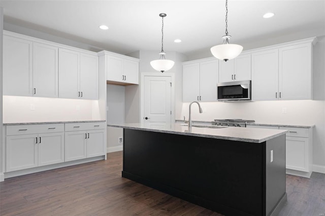 144 Columbia Meadows C Ln, Ofallon, MO 63366 - kitchen featuring stainless steel microwave, a sink, dark wood-type flooring, stove, and recessed lighting