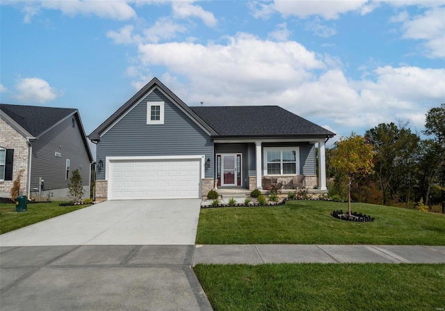 144 Columbia Meadows C Ln, Ofallon, MO 63366 - view of front of house with a front lawn, concrete driveway, a garage, covered porch, and stone siding