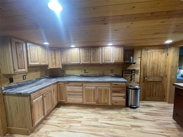 2268 Madison 244, Fredericktown, MO 63645 - kitchen featuring light wood-style floors, wood ceiling, dark countertops, light brown cabinets, and wooden walls