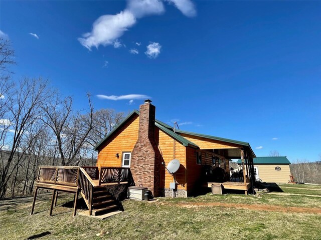 2268 Madison 244, Fredericktown, MO 63645 - back of property with a wooden deck, a chimney, log veneer siding, and a lawn