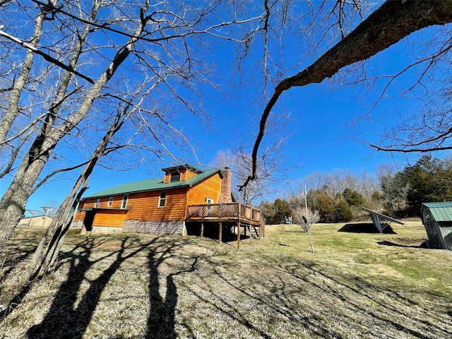 2268 Madison 244, Fredericktown, MO 63645 - view of property exterior with a wooden deck, a lawn, and a chimney