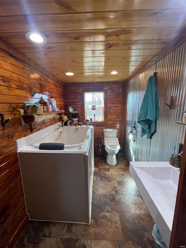2268 Madison 244, Fredericktown, MO 63645 - full bathroom featuring toilet, wooden walls, stone finish floors, wood ceiling, and a bath