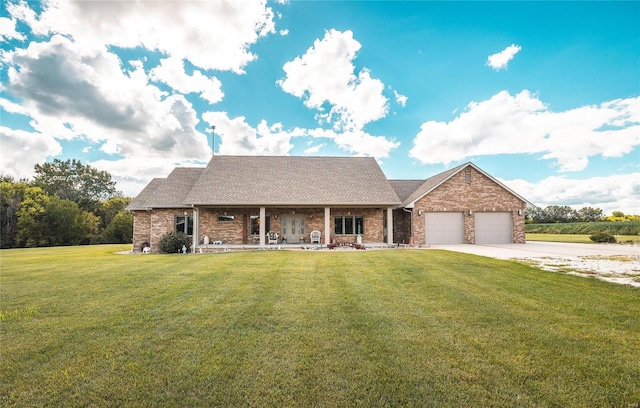 272 NE 1350th Ave, Greenfield, IL 62044 - view of front of property with covered porch, a front lawn, an attached garage, driveway, and brick siding