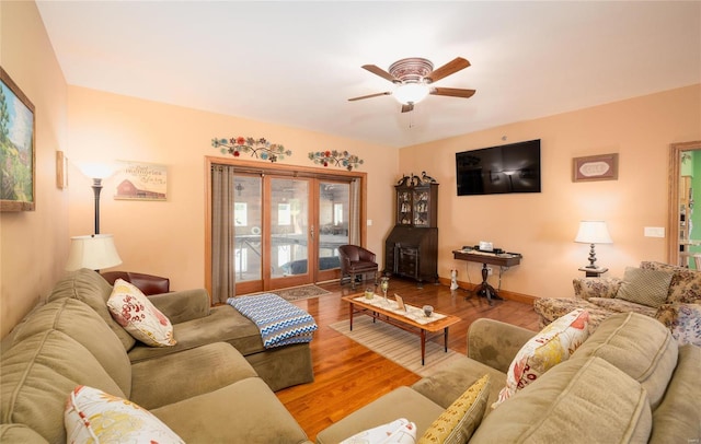 272 NE 1350th Ave, Greenfield, IL 62044 - living area with a wood stove, ceiling fan, wood finished floors, and baseboards