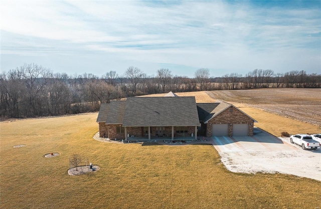 272 NE 1350th Ave, Greenfield, IL 62044 - view of front of home with covered porch, a garage, driveway, a front yard, and stone siding