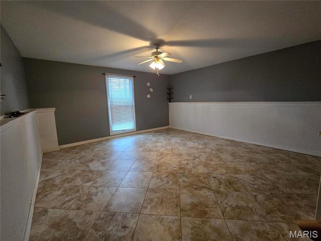 unfurnished room with a ceiling fan