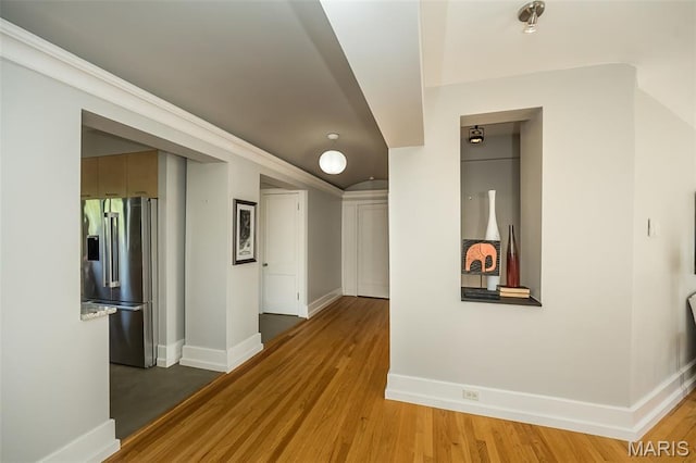 410 N Newstead Ave Unit 6W, Saint Louis, MO 63108 - corridor with baseboards, light wood finished floors, and vaulted ceiling