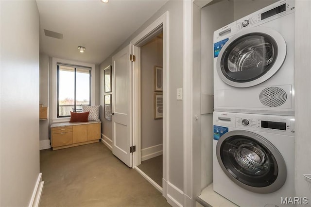 410 N Newstead Ave Unit 6W, Saint Louis, MO 63108 - laundry room with stacked washer / drying machine, baseboards, and light colored carpet