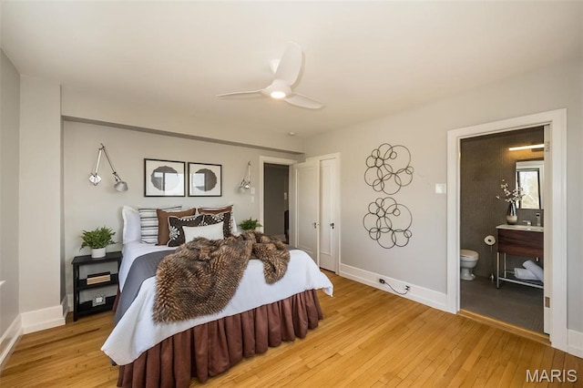 410 N Newstead Ave Unit 6W, Saint Louis, MO 63108 - bedroom with light wood finished floors, ensuite bathroom, baseboards, and ceiling fan